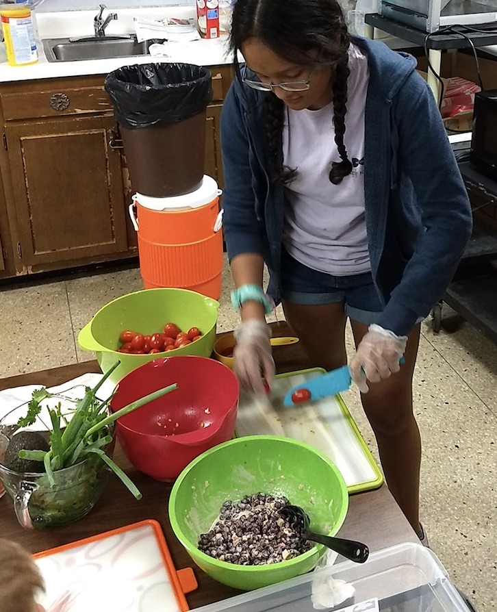 child cutting vegetables