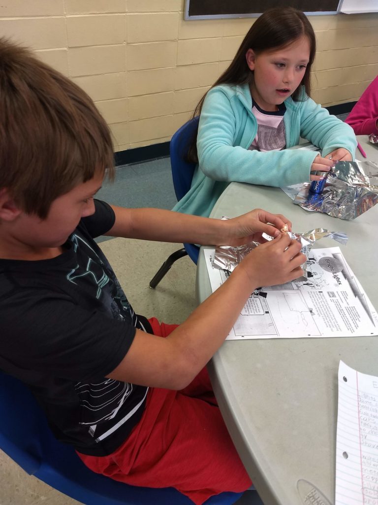 children working on electric project