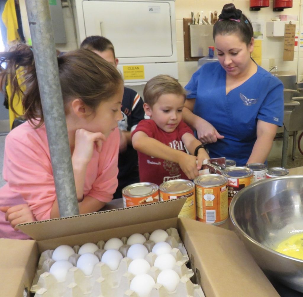 children opening cans of pumpkin