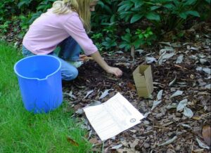 Girl putting soil in a bucket