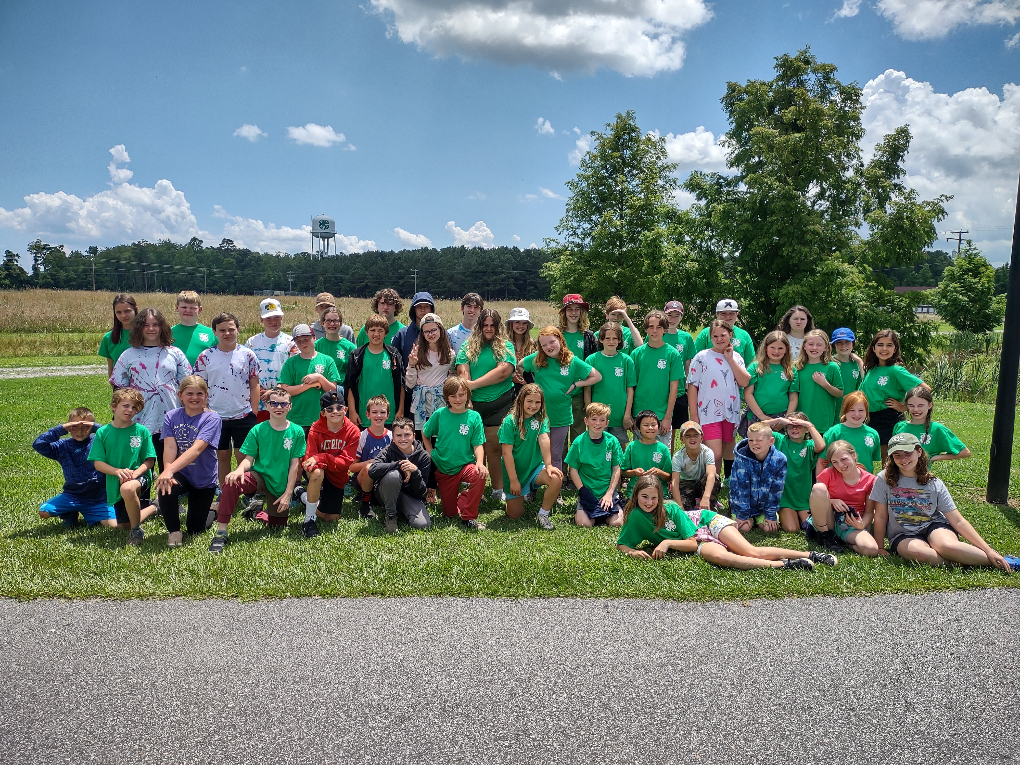 Campers in 4-H shirts gathered on grass