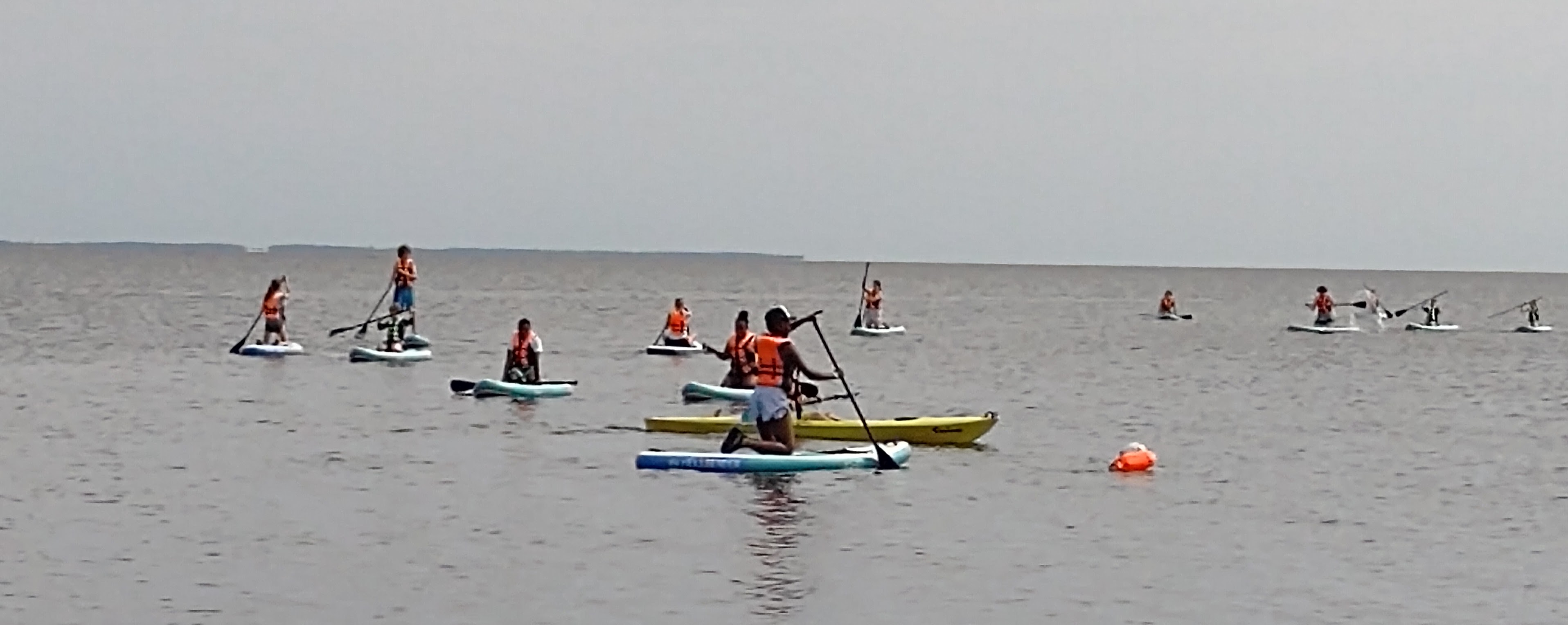 campers out on lake on paddleboards