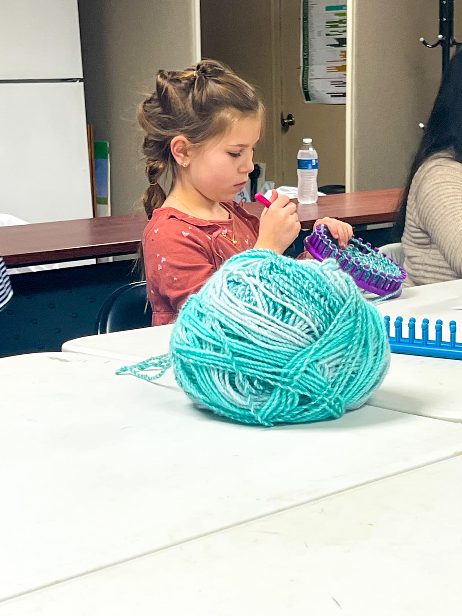 Full Focus: Participant is hard at work to create a loom knitted hat. 